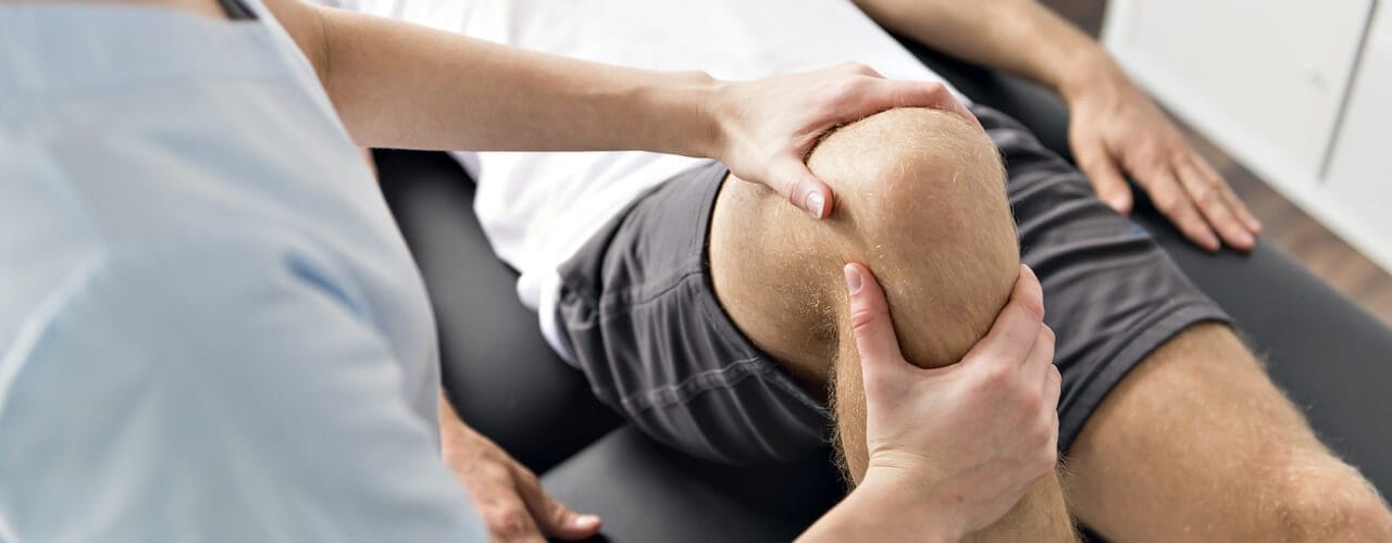 Private physiotherapy treatment on a males knee.